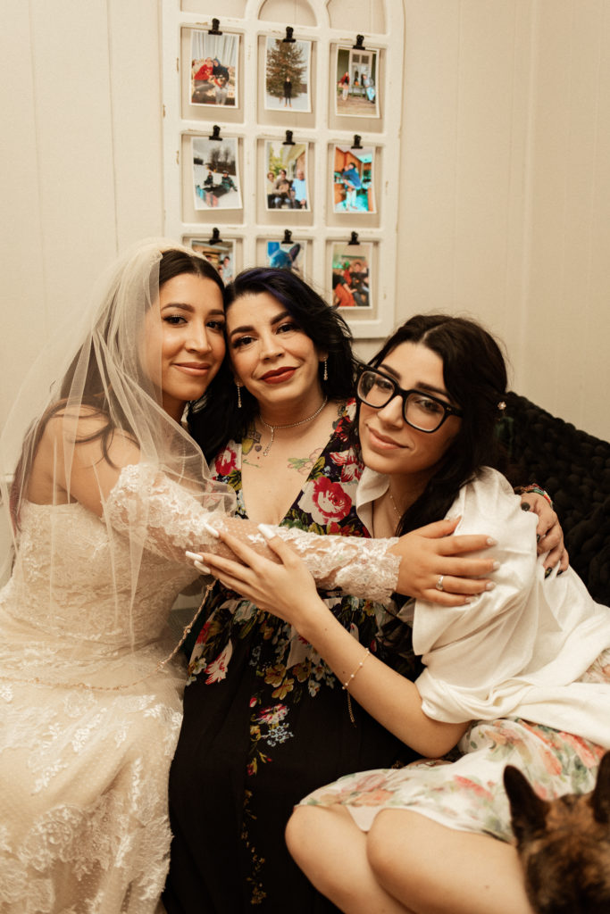 bride hugging her mom and sister