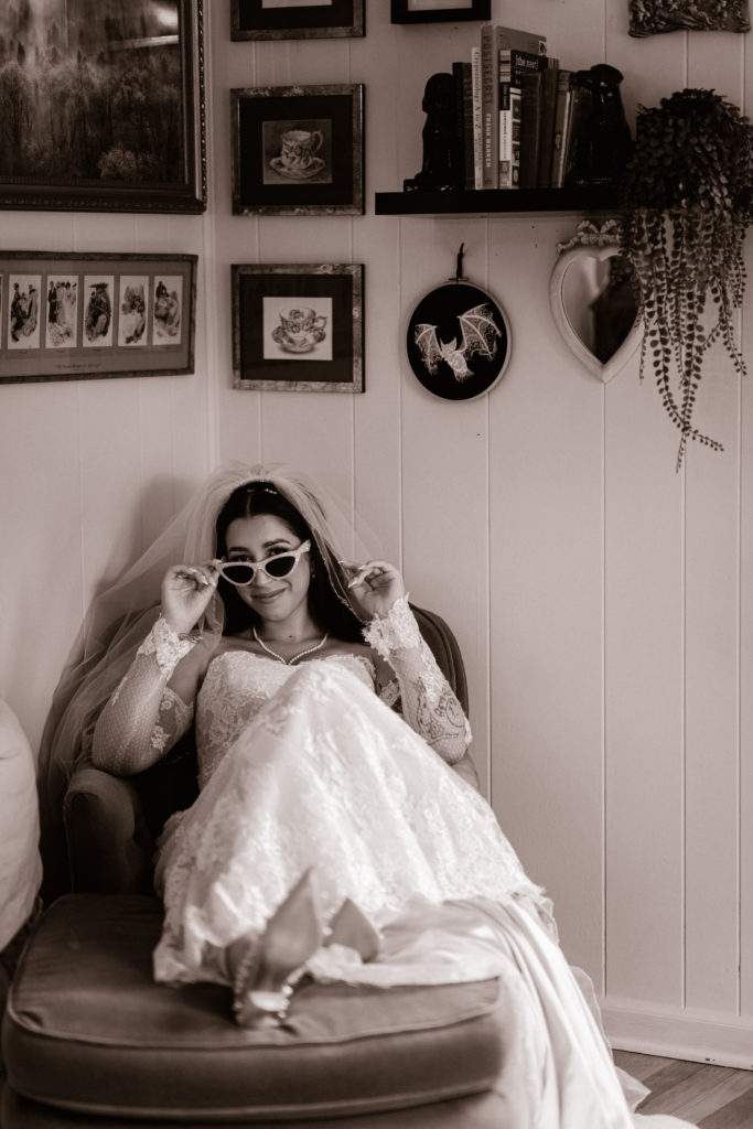 bride posing on couch with sunglasses