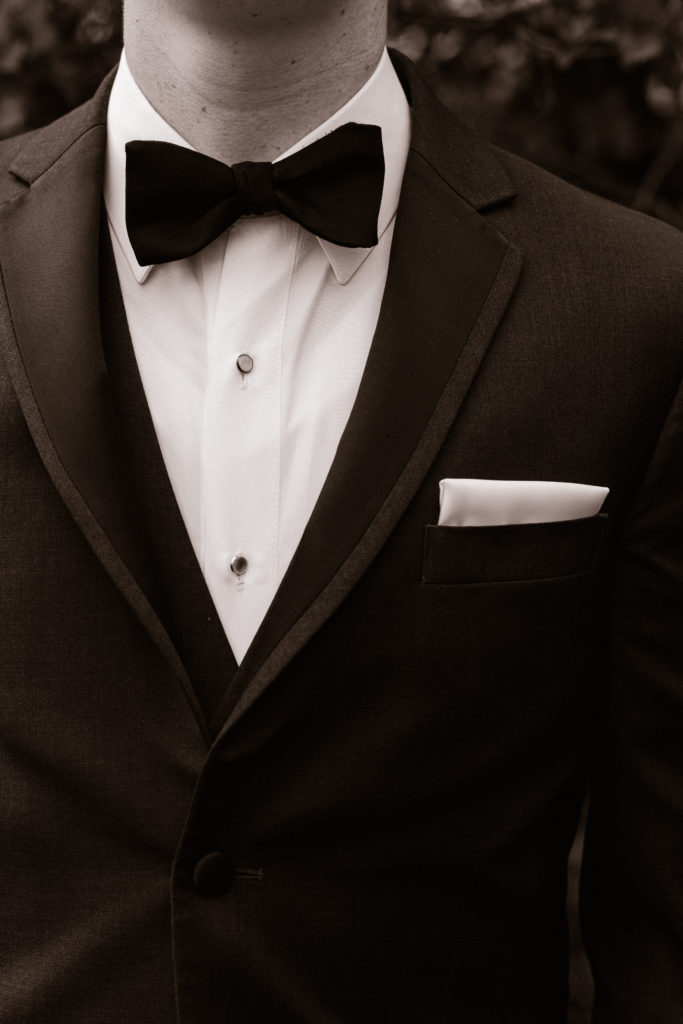 close up of groom's suit