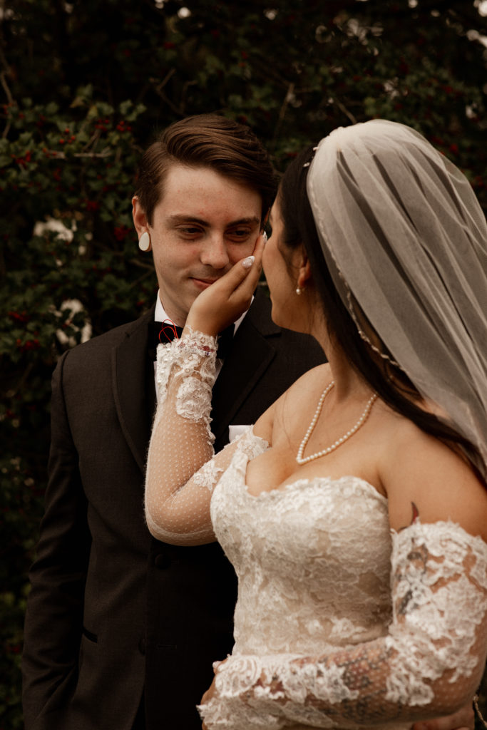 bride holding groom cheek