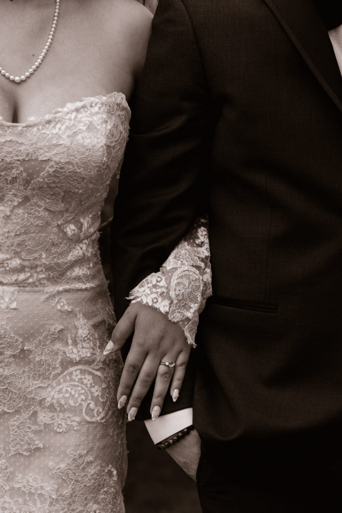 bride's hand on groom's arm