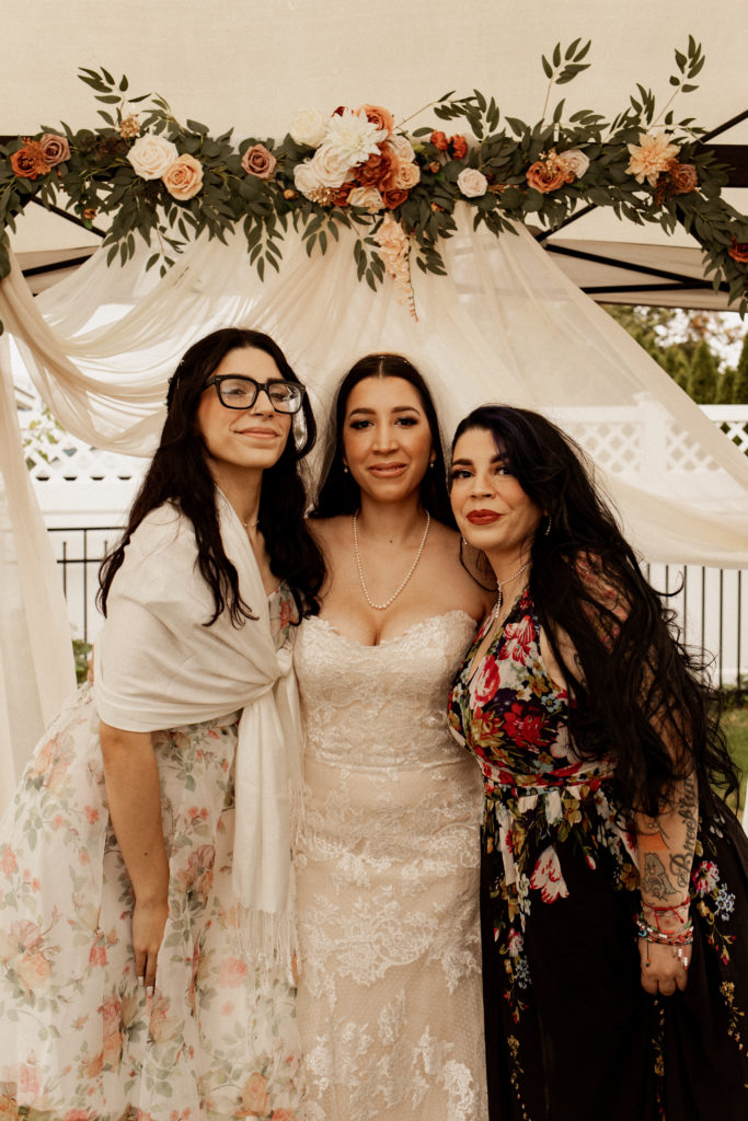 mom and sister with the bride at backyard wedding