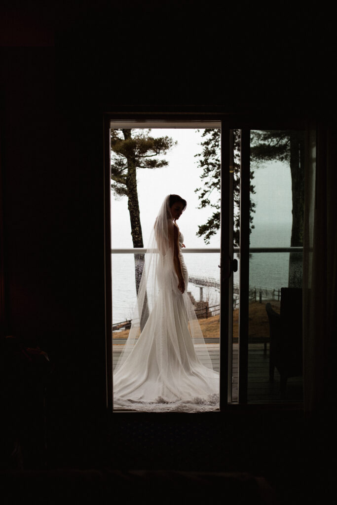 Bride on balcony in Acadia National Park for adventure elopement
