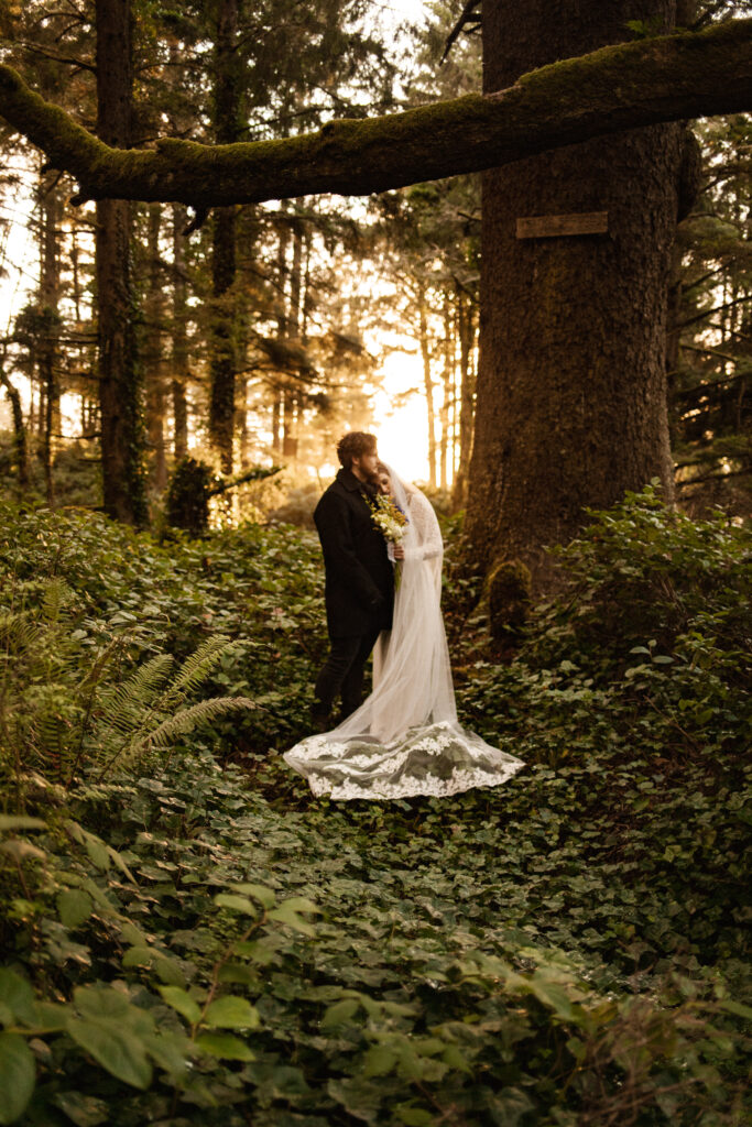 The couple is illuminated by the soft glow of their surroundings, creating a romantic and intimate wedding photography moment.
