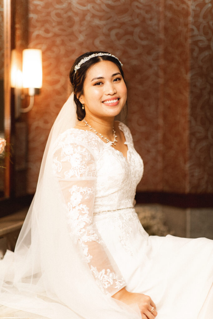 Bride sitting and smiling at the camera. NJ intimate wedding photographer for courthouse weddings.
