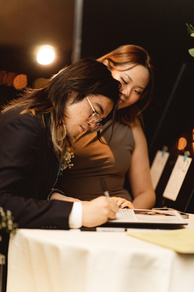 Guest signing the guestbook at the reception. NJ small wedding photographer for intimate weddings.
