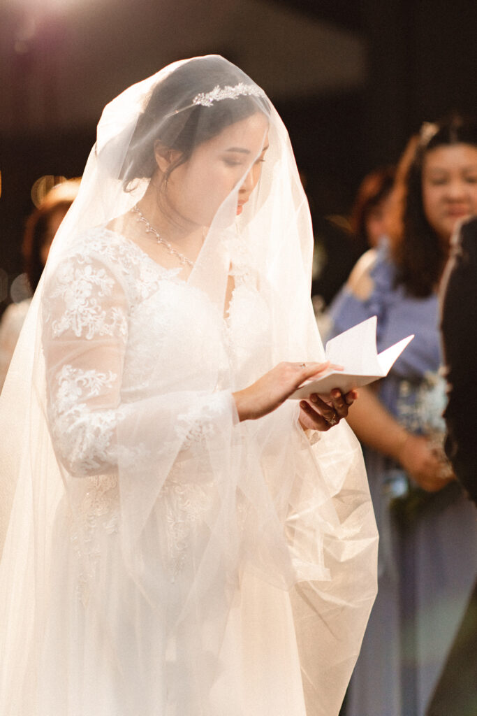 Bride reading her vows during the ceremony. Intimate wedding photographer in NJ for small wedding coverage.
