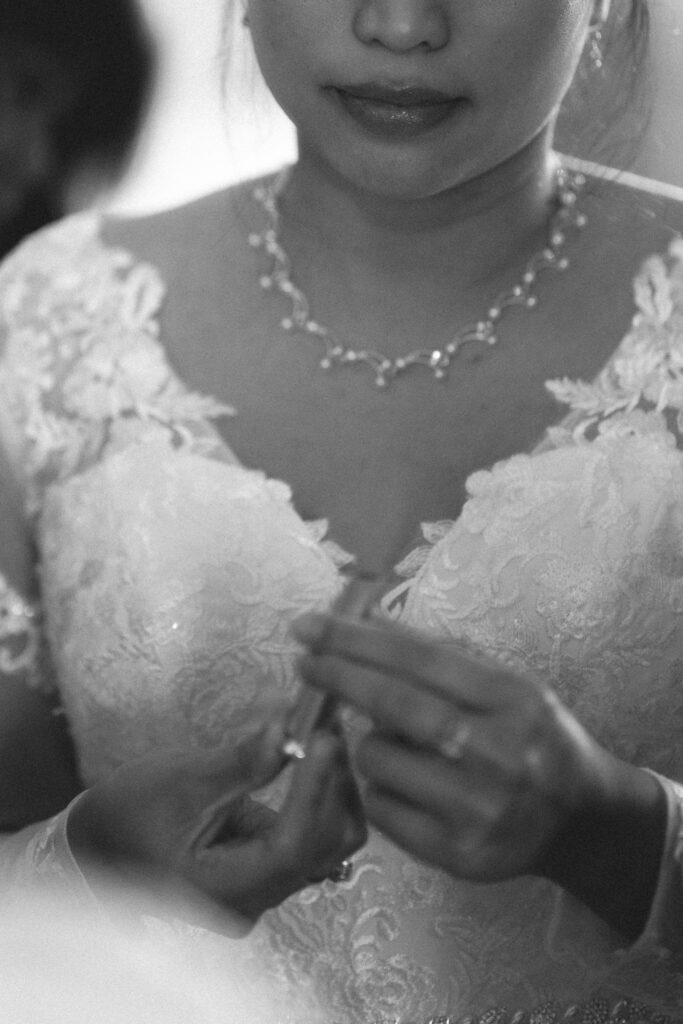 Bride applying lipstick. New Jersey bridal photography by an NJ Micro Wedding Photographer.
