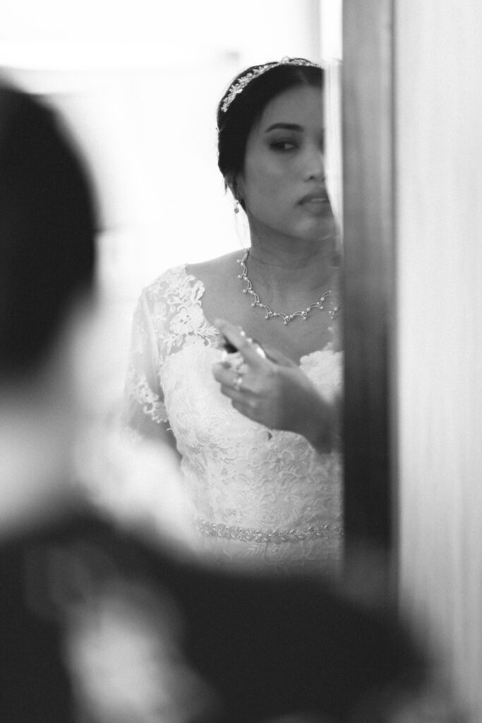 Bride applying final touches before the ceremony. NJ intimate wedding photographer specializing in micro weddings.
