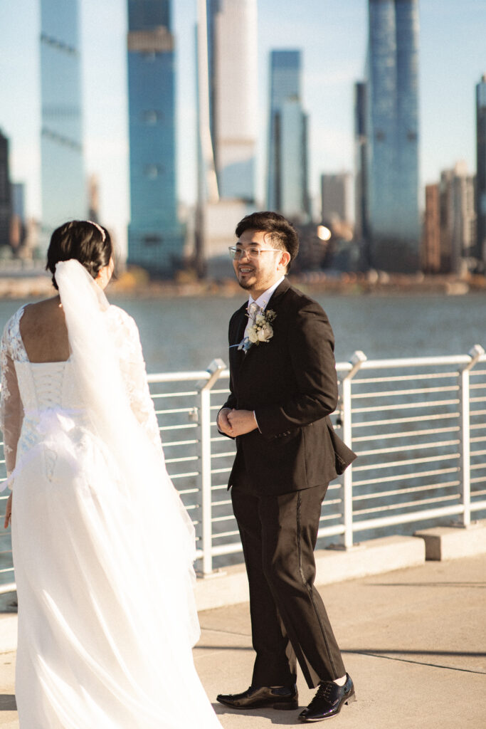 Bride and groom walking and talking together on the pier. New Jersey documentary wedding photographer for elopement photography.

