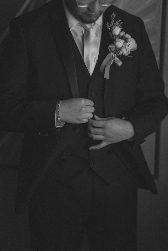 Groom smiling while getting ready. New Jersey micro wedding photographer for intimate wedding coverage.
