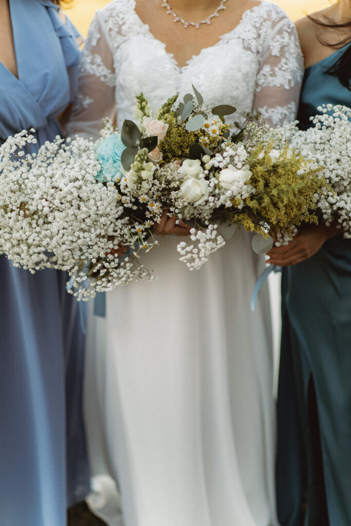Close-up of the bride holding a bouquet of white flowers. New Jersey bridal photography specializing in intimate wedding photography.
