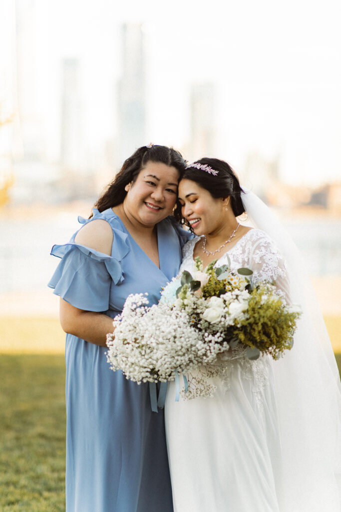 Bride sharing a moment with a bridesmaid. Intimate wedding photographer in NJ capturing genuine emotions.
