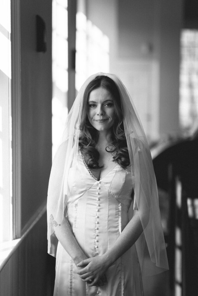 Bride in her gown with a veil, a moment of anticipation before the ceremony, ideal for an intimate wedding photography blog.
