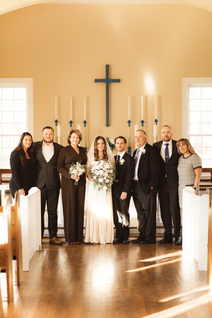 Bride and groom with family members, capturing the essence of intimate wedding photography.
