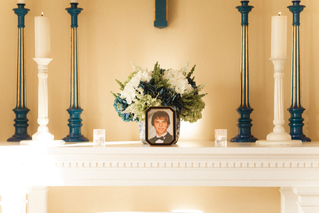 Floral arrangement with a photo of a loved one, honoring those who couldn't be present.
