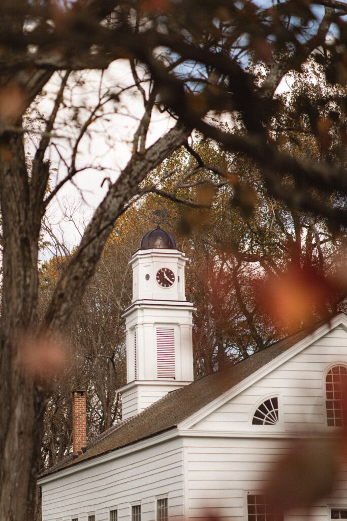 Scenic shot of Allaire Chapel surrounded by autumn trees, illustrating a scenic backdrop for elopement photos.
