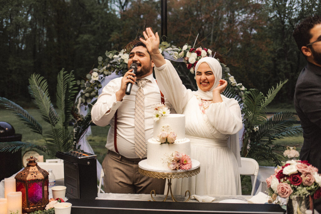 Bride and groom with their wedding cake, surrounded by their closest loved ones at the Katb Ketab ceremony.
