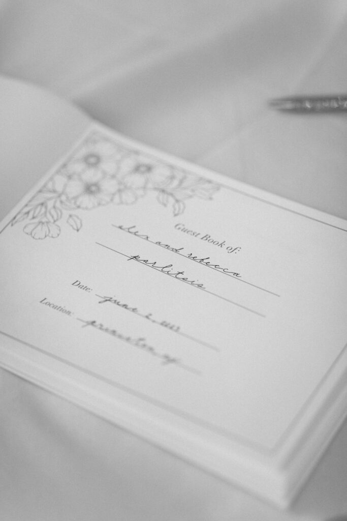 Invitation card for the wedding, placed on a white fabric.