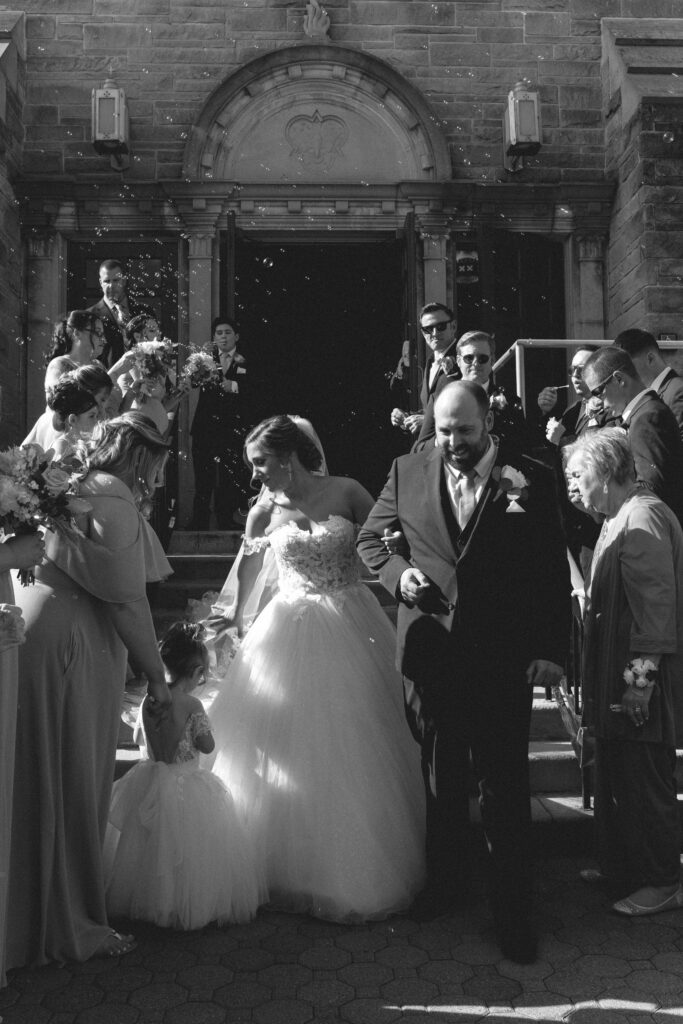 Briana and Pat, with Briana's young flower girl beside them, outside the church.

