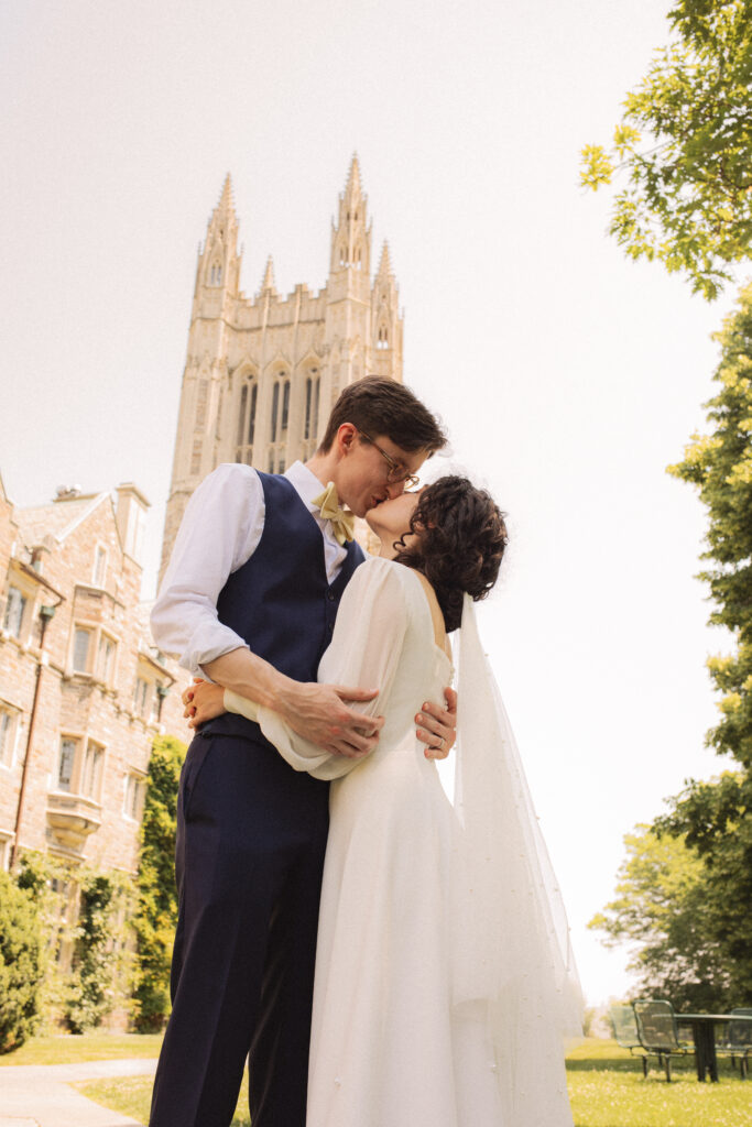 Bride and groom sharing an intimate moment in front of a cathedral.
