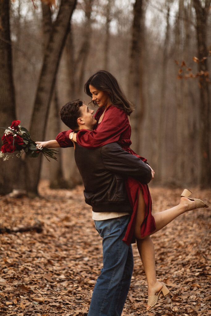 Intimate photograph of a couple, candid photo shoot, red roses. to match the red dress of the girl