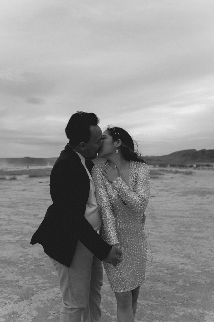 Black and white photo of the bride and groom kissing, their elopement wedding day.
